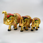 Load image into Gallery viewer, Golden Elephant Trio Figurine (Set of 3 Elephants) – Elegant aluminum handicraft by Tanutra, showcasing modern design and versatility for sophisticated home decor.
