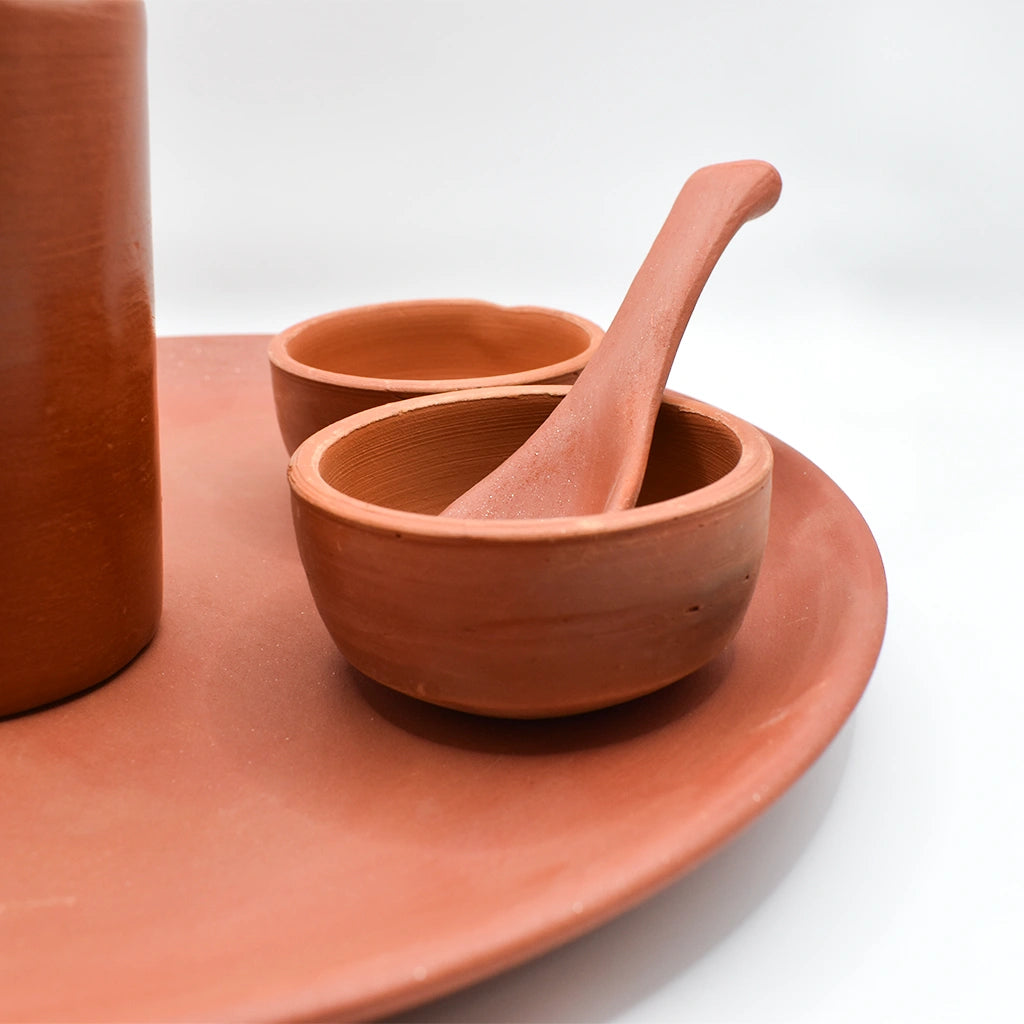 Rustic Harmony Dining Set by Tanutra - Handcrafted clay dinnerware set including plate, tumbler, bowls, and spoon, perfect for everyday meals, special occasions, and culinary presentations. Indian craftsmanship by Gola Clay Art.