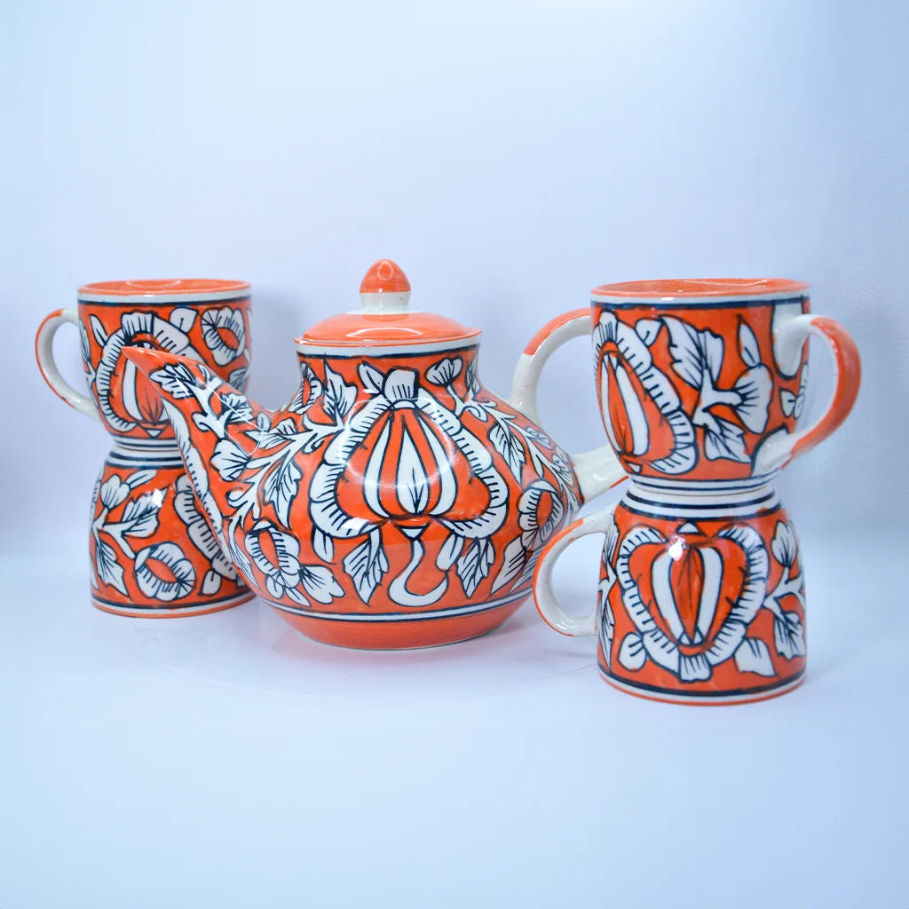 Floral Charm Tea Set by Tanutra - Hand-painted ceramic teapot and cups with vibrant orange and white floral motifs, perfect for tea rituals, home decor, and gifting. Authentic Indian craftsmanship.